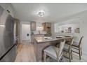 Modern kitchen with stainless steel appliances, a center island with seating, and updated lighting at 1018 Kelly Pl, Longmont, CO 80501