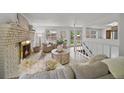 Inviting living room with a brick fireplace, comfortable seating, and access to the outdoors at 1018 Kelly Pl, Longmont, CO 80501