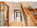 Bright foyer featuring hardwood floors, a staircase with iron railings, and wood trim at 4398 W Lake S Cir, Littleton, CO 80123