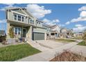 Attractive two-story home with a covered front porch and convenient two-car garage at 21127 E 62Nd Dr, Aurora, CO 80019