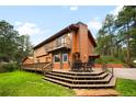 A backyard view shows a deck with outdoor dining area, steps, and some trees at 9633 Fox Valley Dr, Morrison, CO 80465