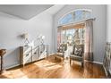 Bright living room with hardwood floors, large windows, and elegant furnishings at 10055 Hughes Pl, Highlands Ranch, CO 80126