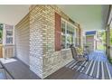 Covered porch with seating area and view of the home's exterior at 1607 Garnet St, Broomfield, CO 80020