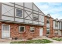 Attractive brick townhouse featuring Tudor-style architectural details and a neatly kept lawn at 677 Vrain St # 10, Denver, CO 80204