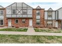 Inviting townhouse exterior with a brick facade, Tudor details, and a pleasant walkway at 677 Vrain St # 10, Denver, CO 80204
