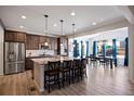 Bright kitchen featuring stainless steel appliances, subway tile backsplash, granite countertops, and adjacent dining area with large windows at 6211 Leilani Ln, Castle Rock, CO 80108