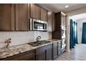 Kitchen with granite countertops, stainless steel appliances, and white subway tile backsplash at 6211 Leilani Ln, Castle Rock, CO 80108