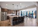 Spacious kitchen with an island, stainless steel appliances, and dark brown cabinets at 6211 Leilani Ln, Castle Rock, CO 80108