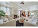 Bright, open living room with fireplace and views into kitchen, perfect for entertaining at 12340 Syracuse St, Thornton, CO 80602