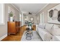 Inviting living room showcases hardwood floors, a comfortable white sofa, and chic decor for a cozy ambiance at 4883 Perry St, Denver, CO 80212