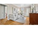 Charming living room features hardwood floors, a plush sofa, and natural light, creating a welcoming and stylish retreat at 4883 Perry St, Denver, CO 80212