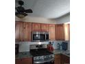 Well-equipped kitchen with stainless steel appliances, light wood cabinetry, and modern subway tile backsplash at 1925 Joliet St, Aurora, CO 80010