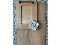 Sample of wood cabinet door, wood flooring, and a granite tile against a speckled countertop background at 4567 Westlock St, Castle Rock, CO 80104