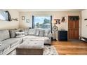 Cozy living room with hardwood floors, a comfortable sofa, and plenty of natural light at 7060 Avrum Dr, Denver, CO 80221