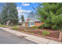 Charming brick home with a well-manicured front yard and mature trees at 3335 S Verbena Ct, Denver, CO 80231