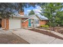Charming brick home with a two car garage and a well-manicured front yard at 3335 S Verbena Ct, Denver, CO 80231