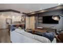 Cozy living room showcases modern design elements, with kitchen view and entertainment setup at 1316 Snowberry Ln # 101, Louisville, CO 80027