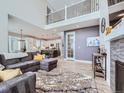 Open-concept living room with contemporary furnishings, a fireplace, and seamless transition to the gourmet kitchen at 938 Larkspur Ln, Louisville, CO 80027