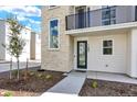 Modern townhome entrance with stone accent wall and small landscaping bed at 11205 W 53Rd Ln, Arvada, CO 80002