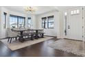 Bright dining room featuring a modern light fixture, rug, and an adjacent door at 1280 Gentle Rain Dr, Castle Rock, CO 80109
