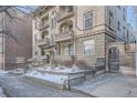 Charming brick apartment building featuring multiple balconies, arched entryways, and landscaped surroundings for a welcoming curb appeal at 125 E 11Th Ave # 2, Denver, CO 80203