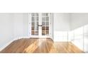 Bright room featuring beautiful french doors and hardwood floors at 5352 Brookside Dr, Broomfield, CO 80020