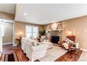 Comfortable living room featuring a stone fireplace, neutral tones, and plush seating that creates a warm and inviting atmosphere at 11605 E Cornell Cir, Aurora, CO 80014