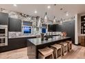 Modern kitchen with dark cabinetry and marble backsplash at 1774 Peak Loop, Broomfield, CO 80023