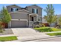 Two-story house with gray siding, a white porch, and a two-car garage at 6112 Black Mesa Rd, Frederick, CO 80516