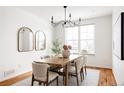 Dining area with a wood table, seating for six, stylish light fixture, and bright natural light at 19473 W 58Th Pl, Golden, CO 80403