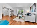 Bright living room with hardwood floors, large window, and comfortable seating area at 11788 E Atlantic Pl, Aurora, CO 80014