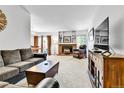 Cozy living room featuring a brick fireplace and built-in shelving at 11788 E Atlantic Pl, Aurora, CO 80014