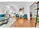 Open-concept living room with hardwood floors and stylish, modern furniture at 11788 E Atlantic Pl, Aurora, CO 80014