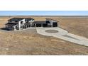 Aerial view of modern home with large driveway and a three-car garage at 12450 Watkins Rd, Hudson, CO 80642