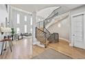 Bright and airy foyer with high ceilings and a modern curved staircase at 12450 Watkins Rd, Hudson, CO 80642
