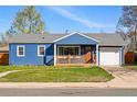 Attractive exterior of a blue single Gathering home with a well-maintained lawn and a detached garage at 1390 S Glencoe St, Denver, CO 80222
