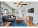 Inviting living room with a ceiling fan, a comfortable couch, and a view of the backyard at 1390 S Glencoe St, Denver, CO 80222