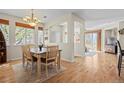 Elegant dining room featuring hardwood floors, a chandelier, and a stylish table with seating for four at 17808 E 104Th Pl # C, Commerce City, CO 80022