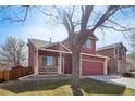Charming two-story home with a well-manicured lawn and an attached two-car garage at 5300 E 129Th Way, Thornton, CO 80241