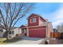 Charming two-story home with a well-manicured lawn and an attached two-car garage at 5300 E 129Th Way, Thornton, CO 80241