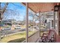 Inviting front porch with chairs, perfect for relaxing and enjoying the neighborhood views at 5300 E 129Th Way, Thornton, CO 80241