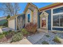 Close-up of a home's front door with a blue exterior, updated landscaping, and visible house number at 19624 E Girard Dr, Aurora, CO 80013