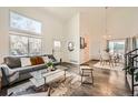 Open concept living area with dark hardwood floors flowing into the dining area at 19624 E Girard Dr, Aurora, CO 80013