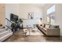 Bright living room featuring hardwood floors, a vaulted ceiling, and a large window at 19624 E Girard Dr, Aurora, CO 80013