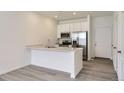 Well-lit kitchen featuring quartz countertops and stainless steel appliances at 14587 W 90Th Ln # B, Arvada, CO 80005