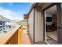 Balcony with beautiful lake views looking into a living room with a TV and an entertainment center at 1890 Argentine St # C301, Georgetown, CO 80444