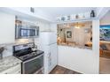 Well-equipped kitchen with stainless steel appliances, granite countertops, and a breakfast bar leading to the dining area at 1890 Argentine St # C301, Georgetown, CO 80444