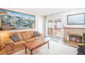 Cozy living room featuring a fireplace, a map of Breckenridge, and a sliding glass door to a deck at 1890 Argentine St # C301, Georgetown, CO 80444