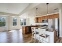 Open kitchen with granite countertops, stainless steel appliances, and stylish pendant lighting at 2200 S University Blvd # 313, Denver, CO 80210