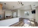 Bright open floor plan with breakfast bar, dining area, and sliding doors to balcony at 2200 S University Blvd # 313, Denver, CO 80210
